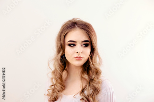 Beautiful model girl with curly hair. Beautiful Young Female wit