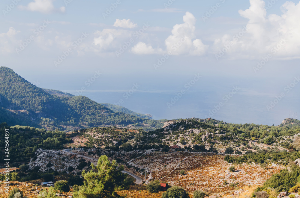 Fototapeta premium Beautiful landscape with calm water and mountains on shore at sunny day, Kas, Antalya, turkey