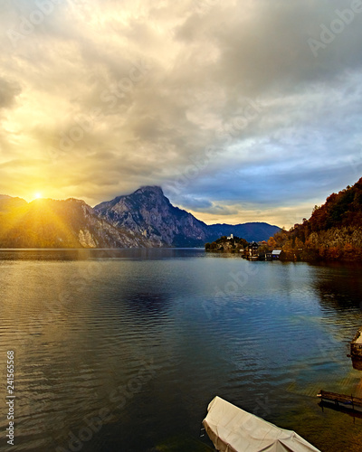 Beautiful scenic sunset over Austrian alps lake. Wooden boat house in alps in Hallstatt mountain village at the lake. Location: resort village Hallstatt, Salzkammergut, Austria, Alps. Cold toned © Vladimir V