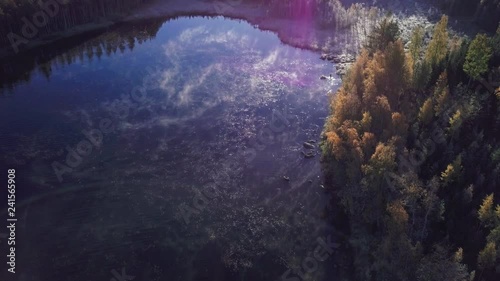 Aerial tilt view of foggy lake in autumn photo
