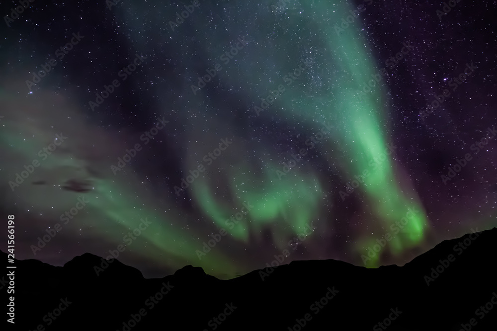 Amazing Aurora Borealis in North Norway (Kvaloya), mountains in the background