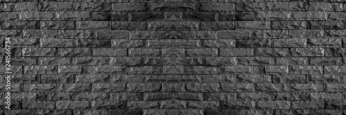 panorama of black brick wall of dark stone texture and background