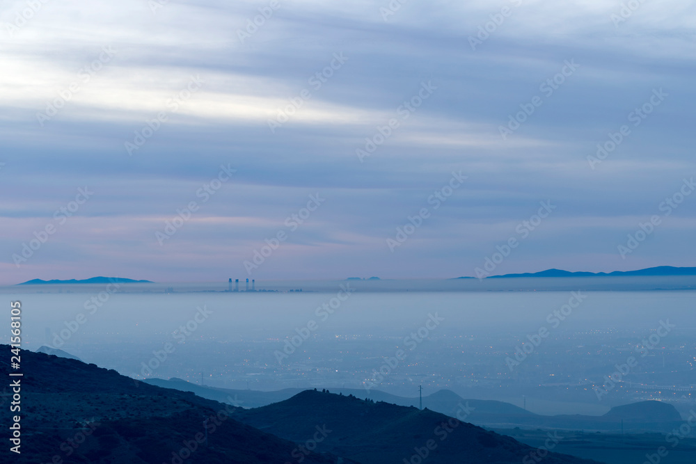 Aereal view of ths city of Madrid with a layer of fog over the city. Aereal view of ths city of Madrid with a layer of fog over the city.