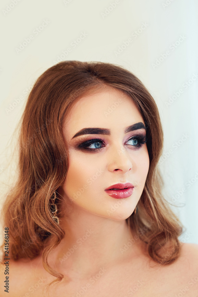 Beautiful model girl with Fashion Luxury Makeup, long eyelashes, perfect skin facial make-up. Beauty Brunette model woman holiday make up close up. Eyelash extensions, false eyelashes. Beauty Woman.