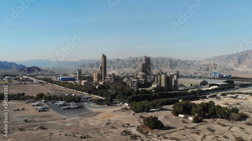 AERIAL. Top view of industry manufactory in UAE. Huge cement factory in desert. photo