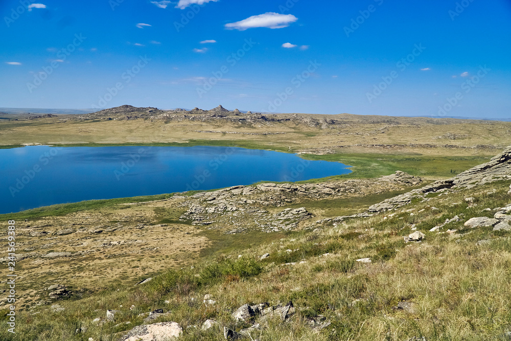 Beautiful summer steppe landscape and Ayr (Monastyri) Lake, located in stone mountains Beautiful summer steppe landscape and Ayr (Monastyri) Lake, located in stone mountains