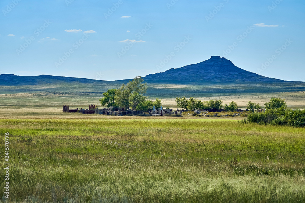 Traditional Kazakh cemetery in the steppe landscape of stone mountains 