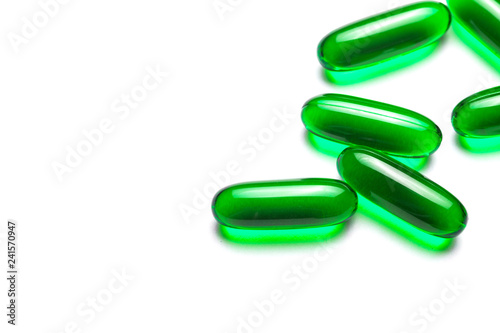 Green capsule painkiller pills isolated on white. Medicine and healthcare background.