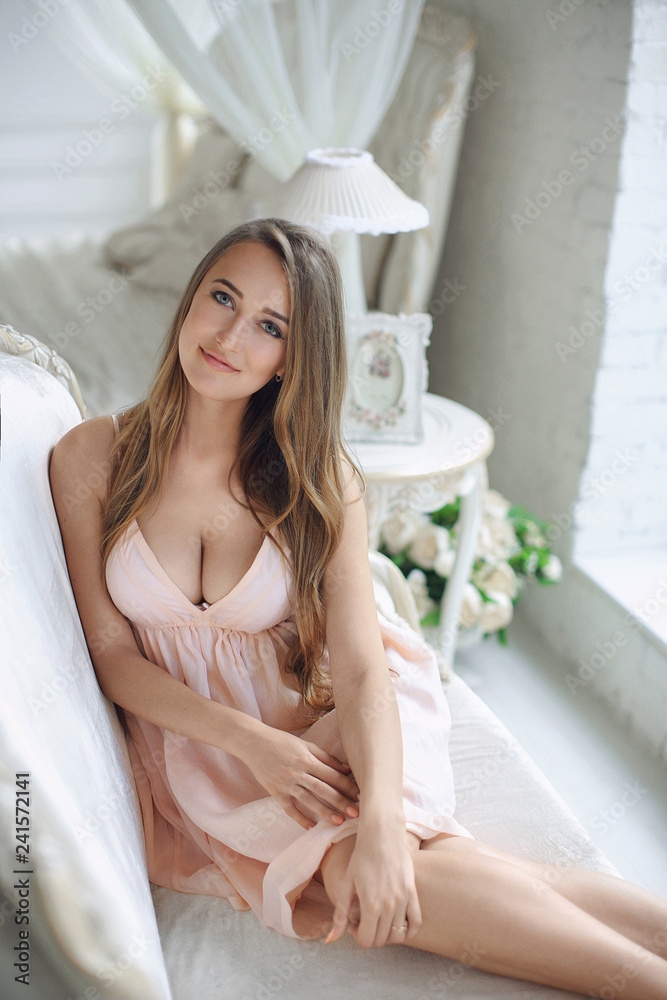 Young beautiful girl with big breasts in a pink dress Stock Photo | Adobe Stock