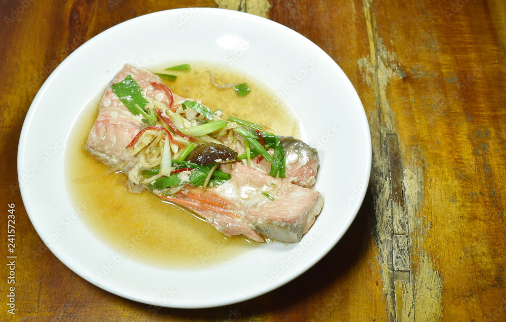 steamed salmon with soy sauce topping slice ginger on plate steamed salmon with soy sauce topping slice ginger on plate