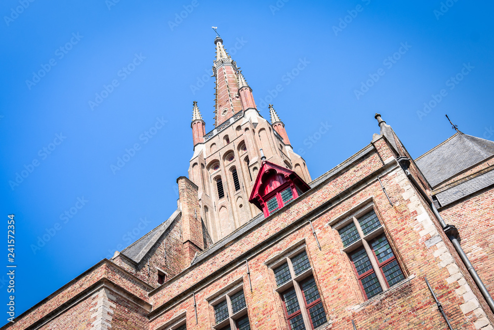 Top view of the Church of Our Lady in Bruges on a clear day with a blue sky, Belgium