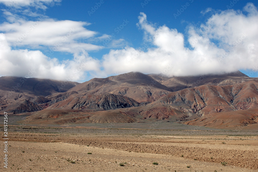 Brown mountains, blue sky and clouds in tibet Brown mountains, blue sky and clouds in tibet