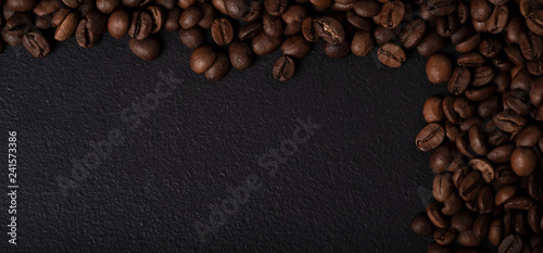 Coffee beans on black metal texture © daphnusia