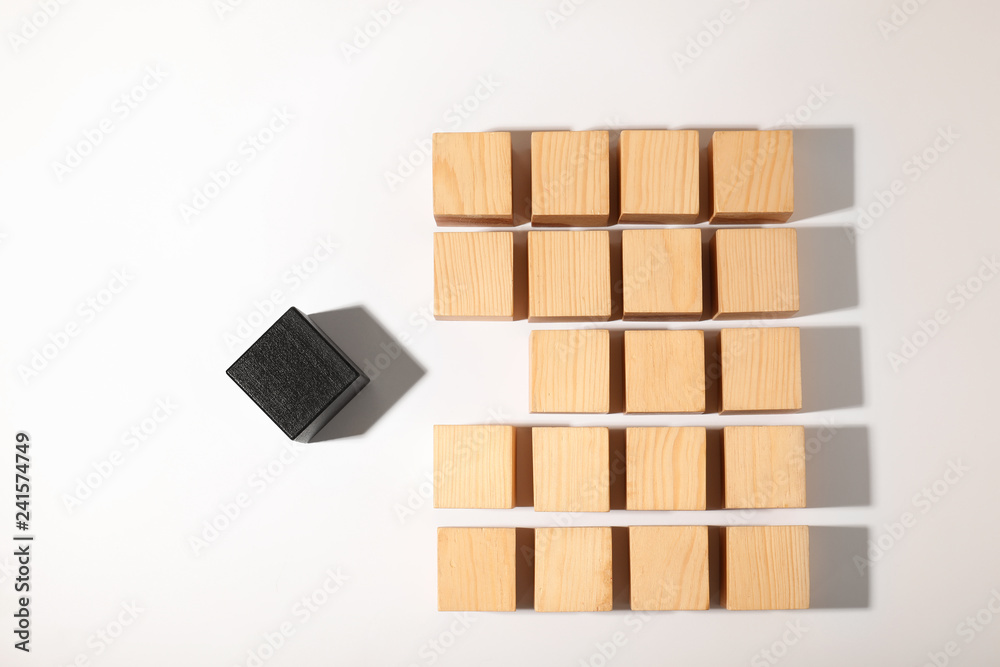 One different cube standing out from others on white background, top view One different cube standing out from others on white background, top view