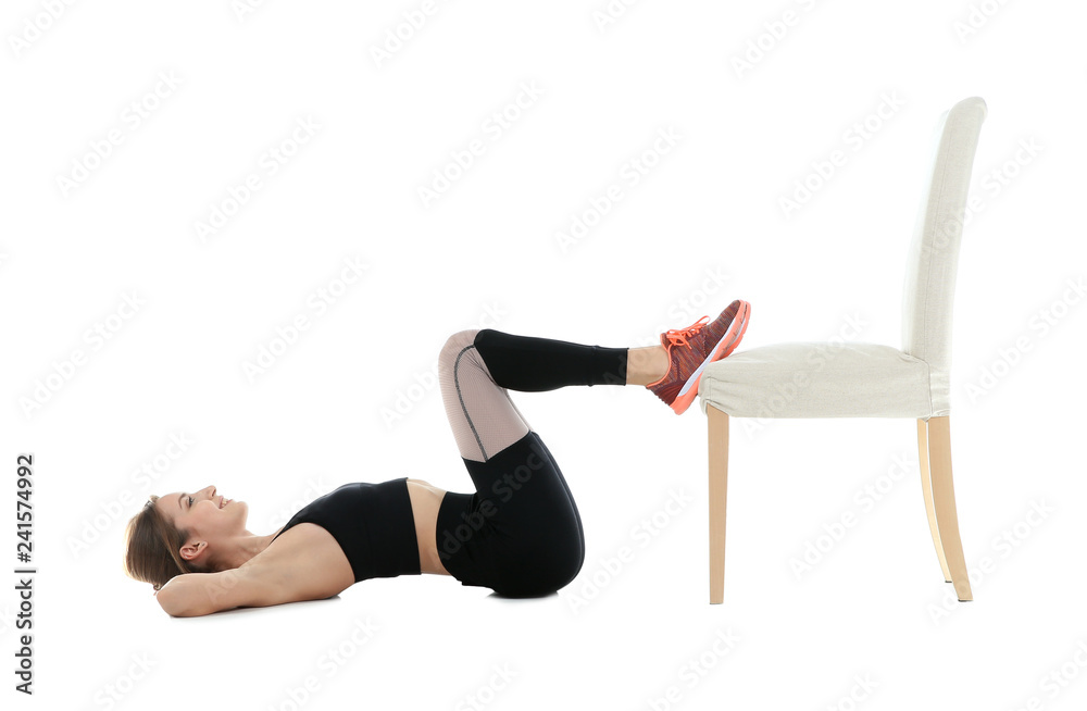 Young woman exercising with chair on white background. Home fitness Young woman exercising with chair on white background. Home fitness