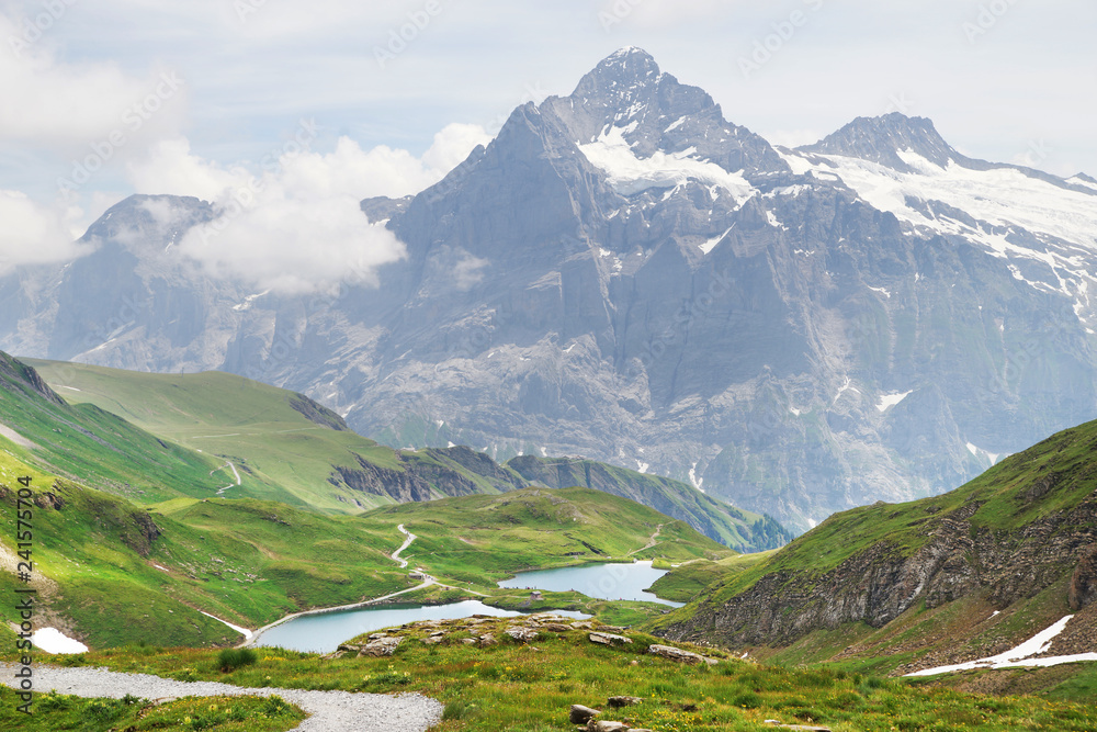 Alpine peaks landskape background. Bachalpsee lake, Grindelwald, Bernese highland. Alps, tourism, journey, hiking concept.