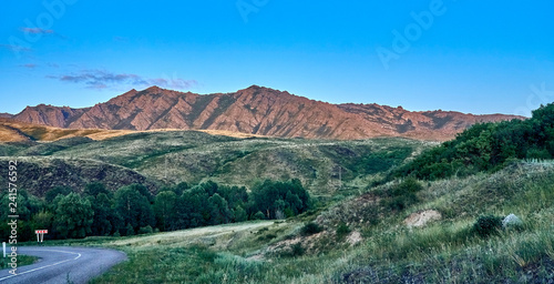 Beautiful landscape of steppe and stone mountains along the road from the city of Ust-Kamenogorsk to the Sibiny lakes (RU: Sibinskiye Ozora: Sadyrkol, Tortkara, Shalkar, Korzhynkol), East Kazakhstan