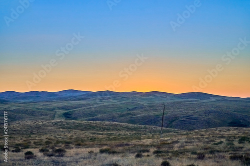 Beautiful landscape of steppe and stone mountains along the road from the city of Ust-Kamenogorsk to the Sibiny lakes (RU: Sibinskiye Ozora: Sadyrkol, Tortkara, Shalkar, Korzhynkol), East Kazakhstan photo