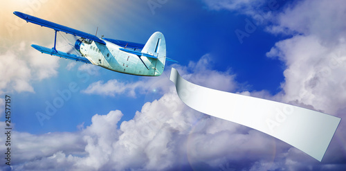 airplane with a banner against a blue sky