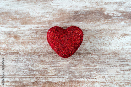 Red heart on a cozy wooden background,  love concept, for Valentine's Day, Mother's Day.