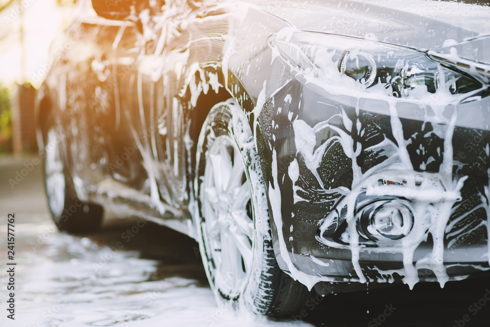 Outdoor car wash with foam soap. Stock Photo