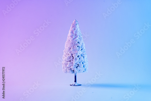 Snowy Christmas tree in vibrant bold gradient holographic colors. Concept art. Minimal New Year surrealism. © Zamurovic Brothers