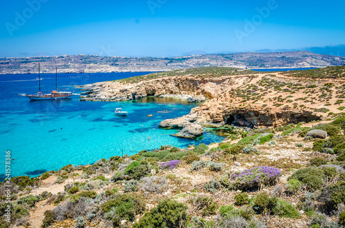 Fototapeta Naklejka Na Ścianę i Meble -  Blue Lagoon, Malta - the caves of the Blue Lagoon on the island of Comino on a bright sunny summer day with blue sky