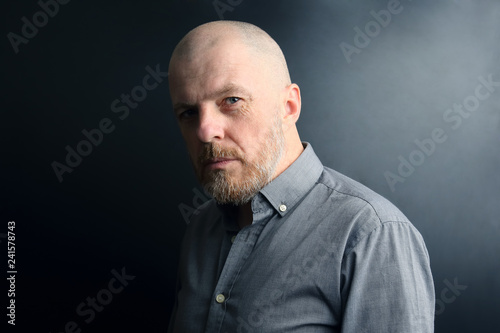 portrait of a bearded man on a dark background