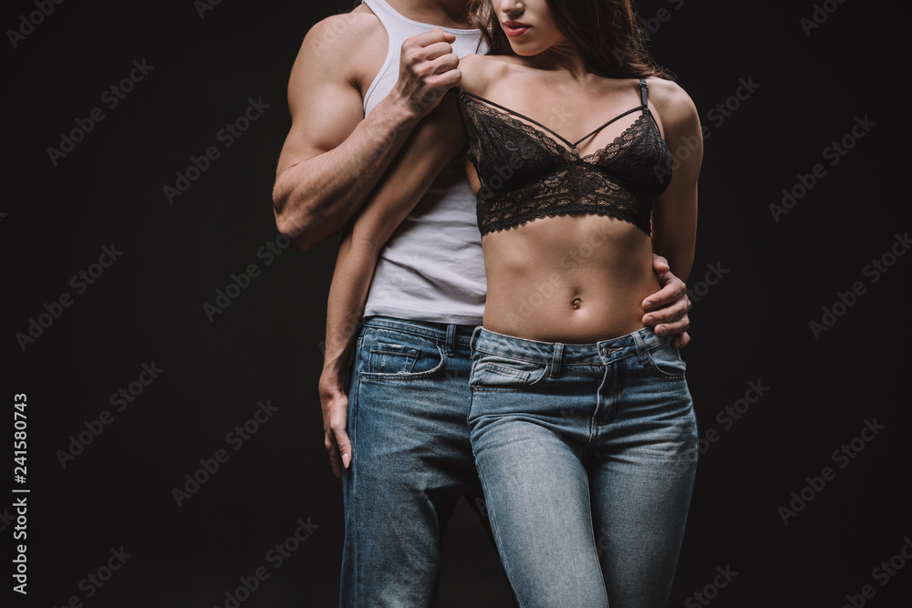 cropped view of man undressing girl in lace bra isolated on black Stock 写真  | Adobe Stock