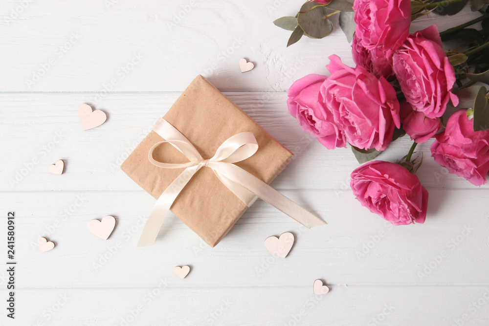 gift, flowers and hearts on a colored background. Background to Valentine's Day or Mother's Day. Holiday, give. International Women's Day. gift, flowers and hearts on a colored background. Background to Valentine's Day or Mother's Day. Holiday, give. International Women's Day.