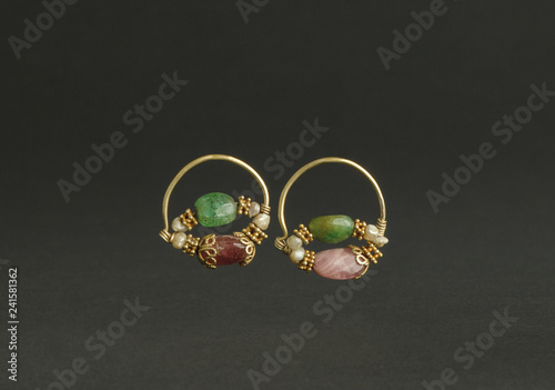 ancient antique earrings with stones on black background. Middle-Asian vintage jewelry photo