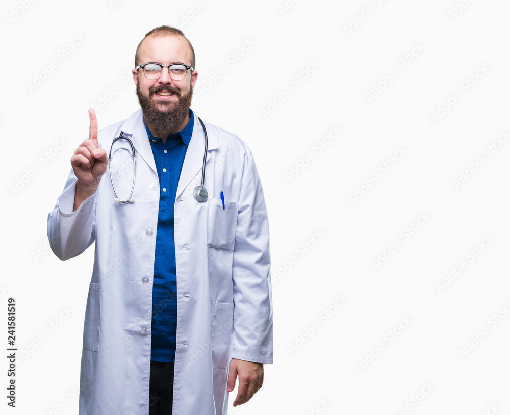 Young caucasian doctor man wearing medical white coat over isolated background showing and pointing up with finger number one while smiling confident and happy. Young caucasian doctor man wearing medical white coat over isolated background showing and pointing up with finger number one while smiling confident and happy.