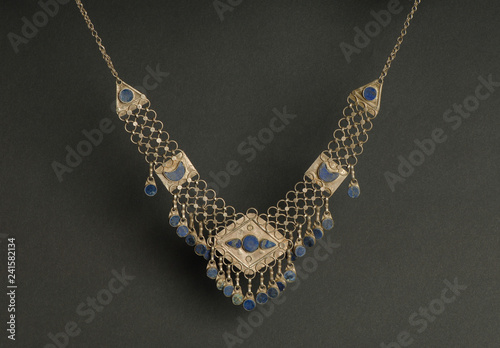 ancient antique pendant with stones on black background. Middle-Asian vintage jewelry photo