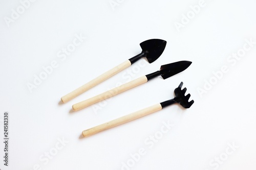 Metallic shovel ,Hoe,Fork,Rake,Spade, with wooden handle isolated , farm tools, clipping path included.Shovel with wooden handle isolated . Flat lay, top view.Mini Shovel. -on white background.