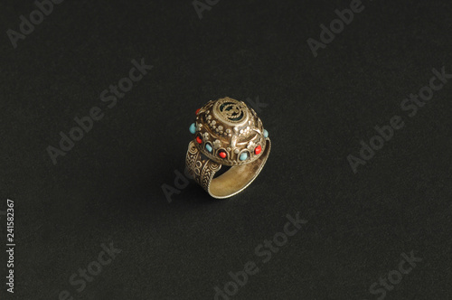 ancient antique ring with stones on black background. Middle-Asian vintage jewelry