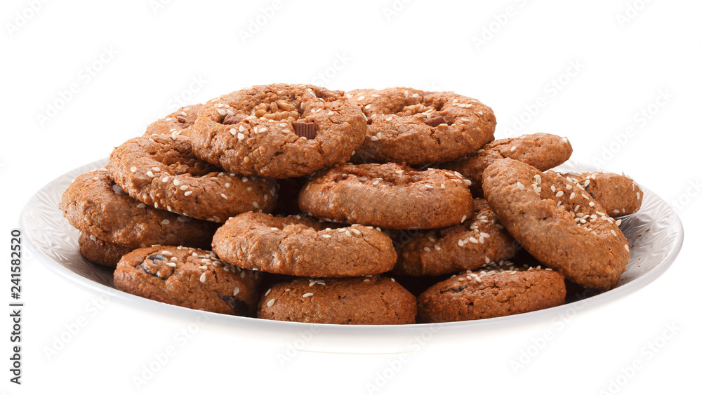 Homemade oatmeal cookies with nuts, chocolate chips and sesame. Isolated on white background.
