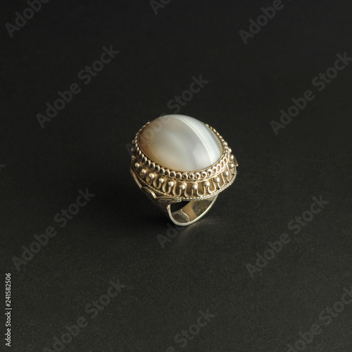 ancient antique ring with stones on black background. Middle-Asian vintage jewelry photo