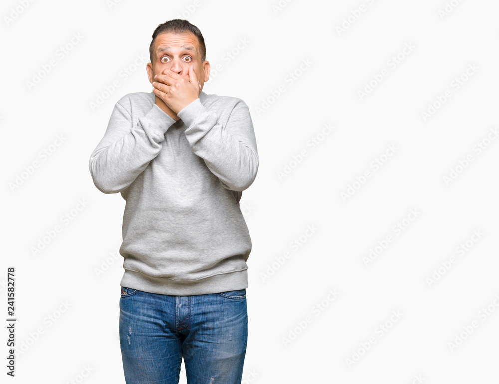 Middle age arab man wearing sport sweatshirt over isolated background shocked covering mouth with hands for mistake. Secret concept. Middle age arab man wearing sport sweatshirt over isolated background shocked covering mouth with hands for mistake. Secret concept.