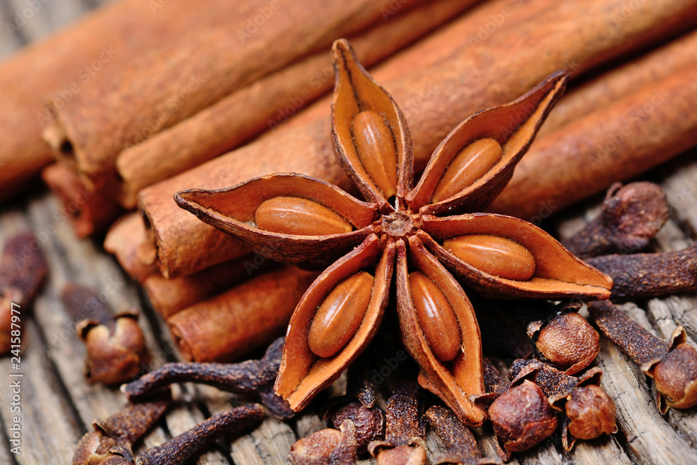 Cinnamon sticks with star anise and cloves on old table