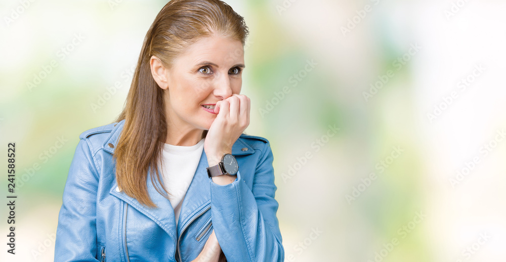 Beautiful middle age mature woman wearing fashion leather jacket over isolated background looking stressed and nervous with hands on mouth biting nails. Anxiety problem.