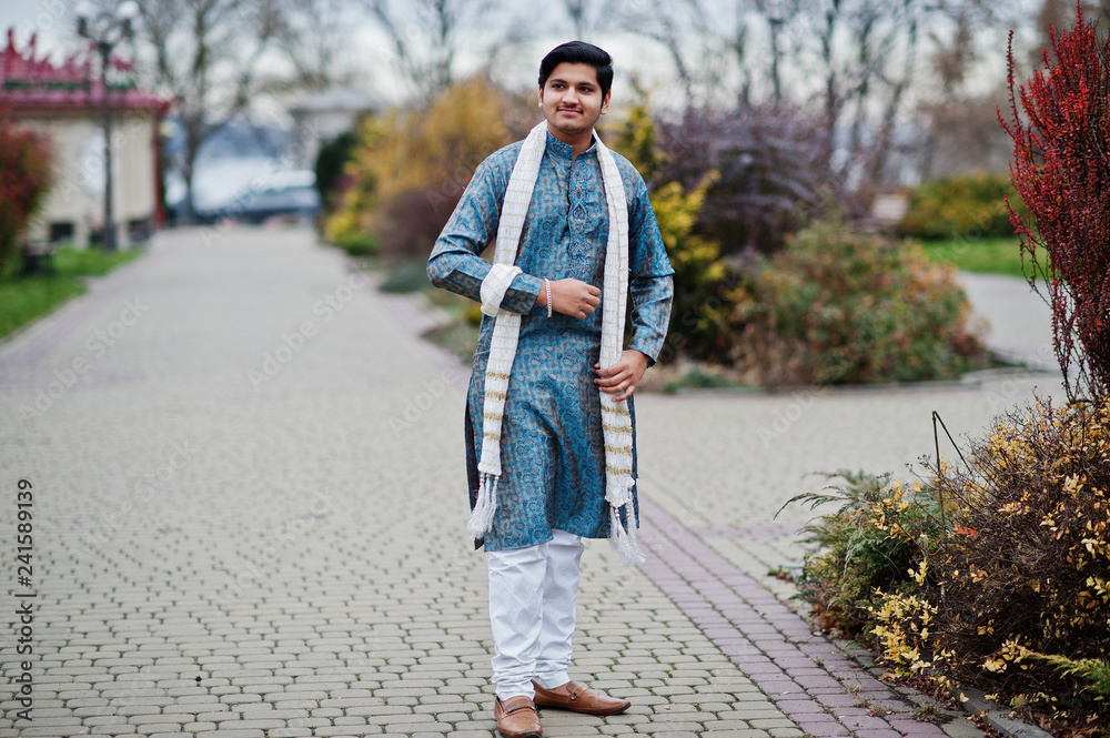 Indian man wear on traditional clothes with white scarf posed outdoor.