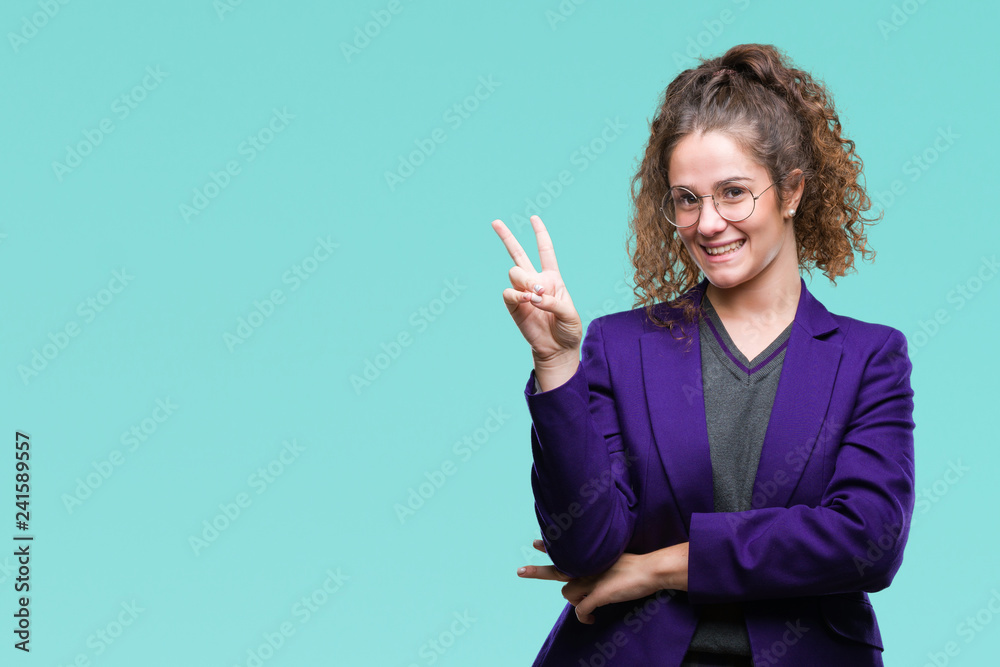 Young brunette student girl wearing school uniform and glasses over isolated background smiling with happy face winking at the camera doing victory sign. Number two. Young brunette student girl wearing school uniform and glasses over isolated background smiling with happy face winking at the camera doing victory sign. Number two.
