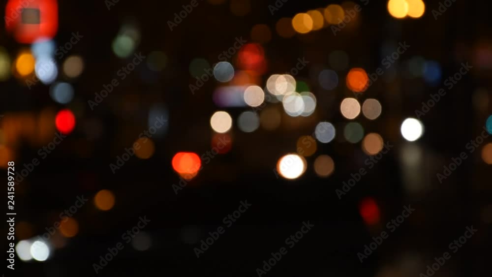 Background with car lights and silhouettes – defocused image of the night street Background with car lights and silhouettes – defocused image of the night street