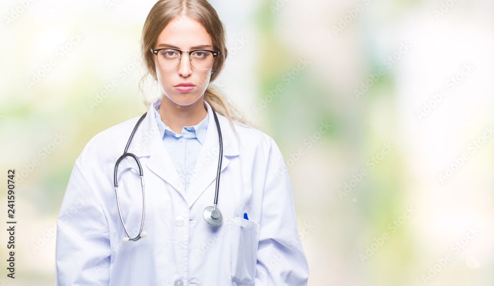 Beautiful young blonde doctor woman wearing medical uniform over isolated background depressed and worry for distress, crying angry and afraid. Sad expression. Beautiful young blonde doctor woman wearing medical uniform over isolated background depressed and worry for distress, crying angry and afraid. Sad expression.