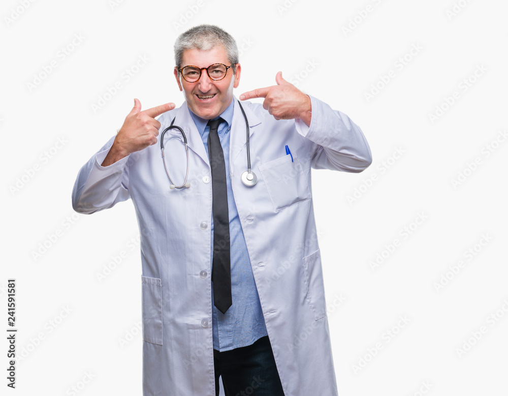 Handsome senior doctor man over isolated background smiling confident showing and pointing with fingers teeth and mouth. Health concept. Handsome senior doctor man over isolated background smiling confident showing and pointing with fingers teeth and mouth. Health concept.