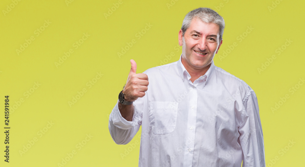 Naklejka premium Handsome senior man over isolated background doing happy thumbs up gesture with hand. Approving expression looking at the camera with showing success.
