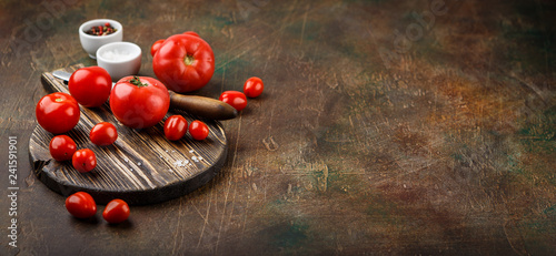 Close up knife and tomato on wooden table