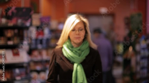 Wallpaper Mural Young woman taking products from store shelves at supermarket. Torontodigital.ca