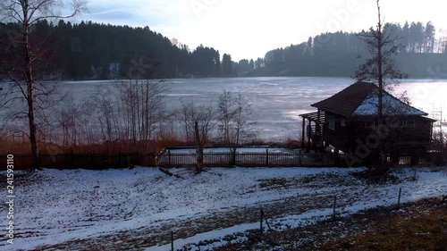 Aerial view of a frozen little Lake in Switzerland at a sunny winter Day