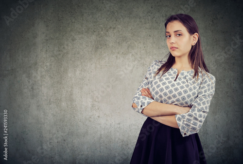 Fotografie Arrogant young woman with arms crossed